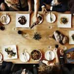 dinner depositphotos_114751052-stock-photo-diverse-people-having-dinner-together