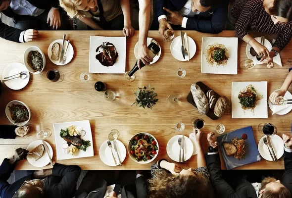 dinner depositphotos_114751052-stock-photo-diverse-people-having-dinner-together
