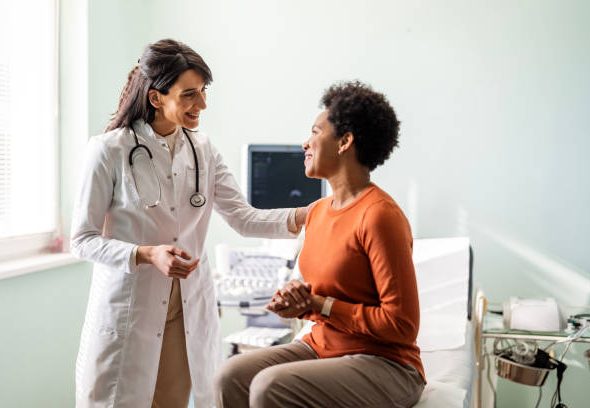 Female medical practitioner reassuring a patient